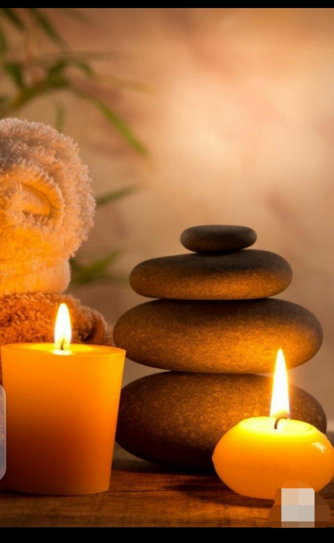 Candles and massage stones set out at the spa