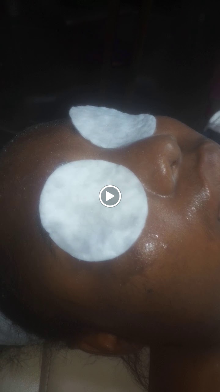 Client wearing a facial mask with cooling eye pads