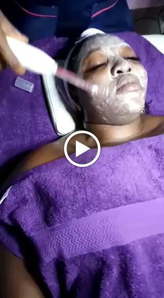 Facial treatment with a skincare device at Shosho Beauty Spa
