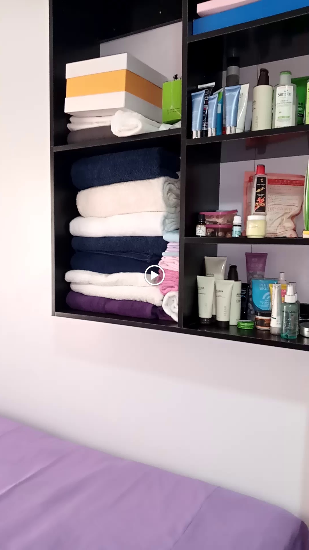 Skincare products and towels on the shelves at Shosho Beauty Spa