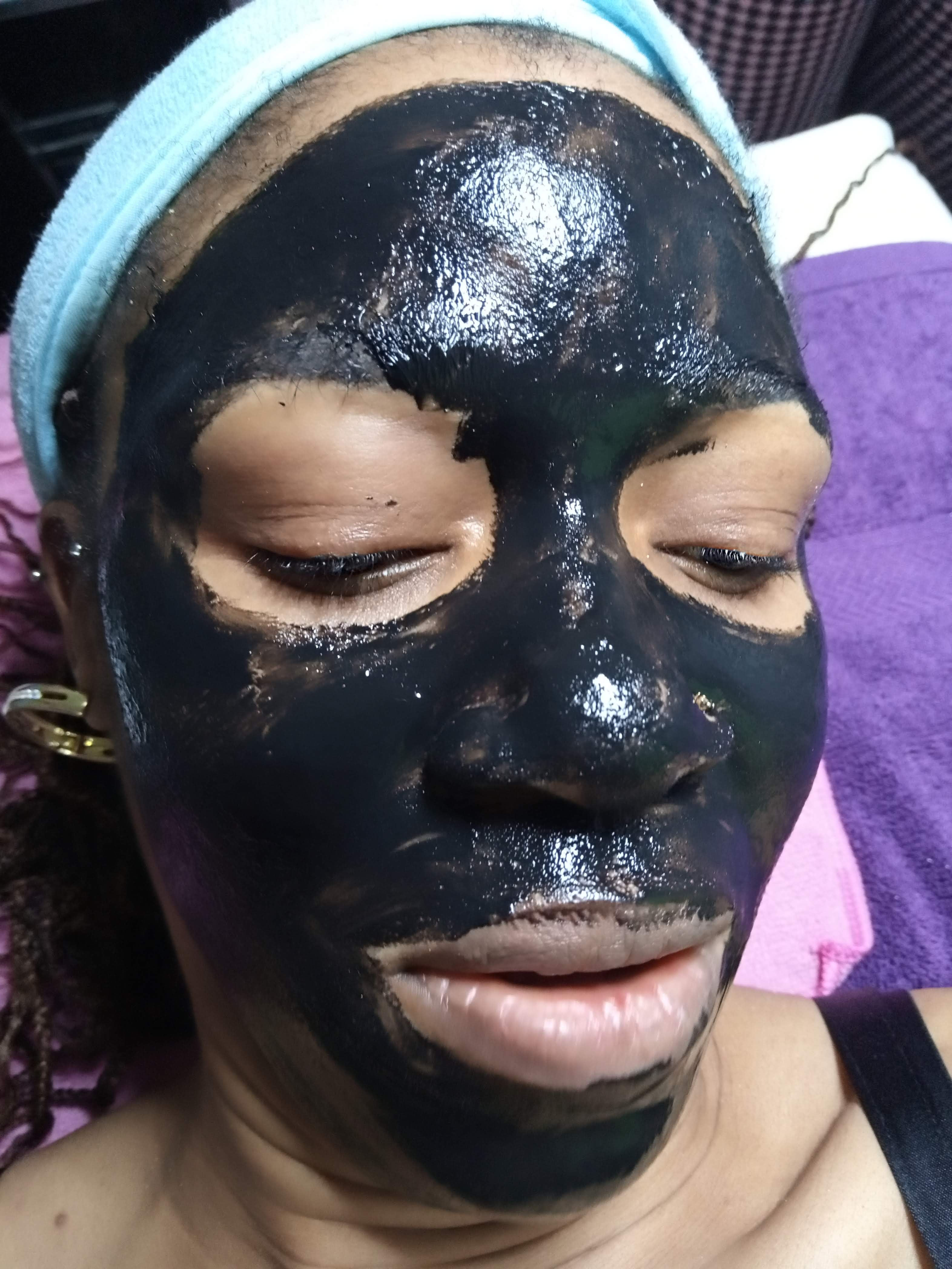 Detoxifying black mask applied during a facial