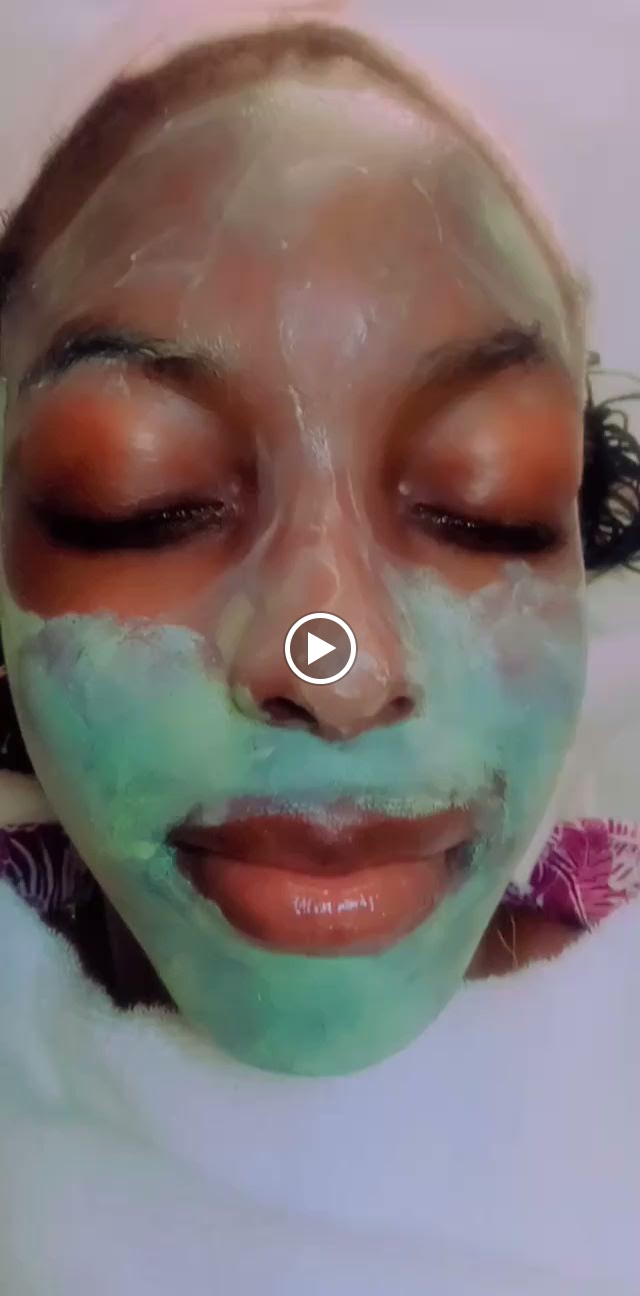 Green clay face mask during a facial