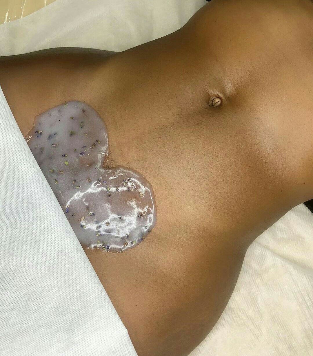 Wax applied on the stomach during a body waxing session