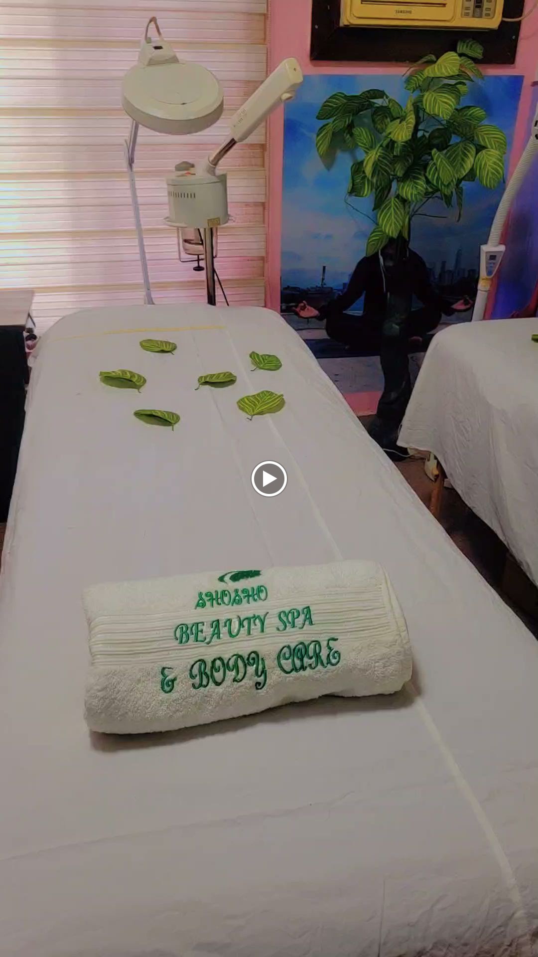 Massage bed prepared with towels and leaves at Shosho Beauty Spa