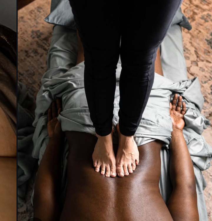 Thai massage using foot pressure on the back